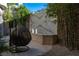 Relaxing backyard patio with hanging chair and stone wall at 1635 Liege Dr, Henderson, NV 89012