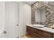 Modern bathroom with a vessel sink, mosaic tile accent wall, and a stylish vanity, creating a spa-like retreat at 1635 Liege Dr, Henderson, NV 89012