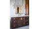 Modern bathroom featuring a double vanity with dark wood cabinets and a large mirror at 1635 Liege Dr, Henderson, NV 89012