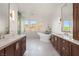 Bathroom featuring a soaking tub between two vanities with marble countertops and modern fixtures at 1635 Liege Dr, Henderson, NV 89012