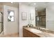 Bathroom featuring tiled counters and shower, with a decorative mirror at 1635 Liege Dr, Henderson, NV 89012