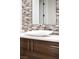 Elegant bathroom with a modern white vessel sink and mosaic tile backsplash at 1635 Liege Dr, Henderson, NV 89012