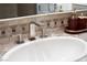 Bathroom with modern sink, faucet, and stone tile at 1635 Liege Dr, Henderson, NV 89012