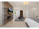 Serene bedroom featuring a cozy sitting area, modern fireplace and access to the patio, a relaxing retreat at 1635 Liege Dr, Henderson, NV 89012