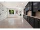 Large bonus room with black cabinets and stone accent wall at 1635 Liege Dr, Henderson, NV 89012