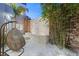 Beautiful courtyard with a stone accent wall, bamboo, and a unique hanging chair at 1635 Liege Dr, Henderson, NV 89012