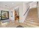 Welcoming foyer featuring travertine flooring and staircase at 1635 Liege Dr, Henderson, NV 89012