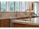 Kitchen island with a sink, gold faucet, and granite countertop at 1635 Liege Dr, Henderson, NV 89012