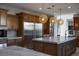 Spacious kitchen island with stainless steel appliances and modern lighting at 1635 Liege Dr, Henderson, NV 89012