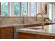 Elegant kitchen sink featuring modern faucet and stone countertops at 1635 Liege Dr, Henderson, NV 89012