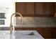 Modern kitchen sink with a sleek, gold faucet and marble countertop at 1635 Liege Dr, Henderson, NV 89012