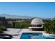 Outdoor poolside scene featuring a covered outdoor daybed, patio furniture, and lush foliage at 1635 Liege Dr, Henderson, NV 89012