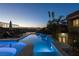 Inviting backyard pool and spa featuring modern lighting and luxurious lounge furniture, perfect for evening relaxation at 1635 Liege Dr, Henderson, NV 89012