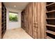 Well-organized walk-in closet with custom wood shelving and drawers, providing ample storage space at 1635 Liege Dr, Henderson, NV 89012