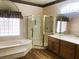 Bathroom with double sinks, walk-in shower, and a large bathtub at 1736 Williamsport St, Henderson, NV 89052