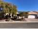 Single-story house with a two-car garage and landscaped front yard at 1736 Williamsport St, Henderson, NV 89052