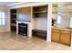 Living room with fireplace, built-in shelving, and wet bar at 1736 Williamsport St, Henderson, NV 89052