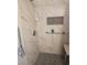 Bathroom with shower, grab bars, and tiled walls at 1920 Walnut Ave, Las Vegas, NV 89101