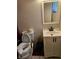 Bathroom with toilet, vanity, and a mirror at 1920 Walnut Ave, Las Vegas, NV 89101