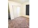 Bedroom with gray carpet, closet and window at 1920 Walnut Ave, Las Vegas, NV 89101