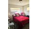 Bedroom with a red bedspread, nightstand, and chair at 1920 Walnut Ave, Las Vegas, NV 89101