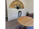 Dining room with a round wooden table and an ornate wall hanging at 1920 Walnut Ave, Las Vegas, NV 89101