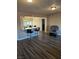 Living room with gray vinyl flooring, a rocker recliner, and kitchen island at 1920 Walnut Ave, Las Vegas, NV 89101