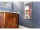 Bathroom features a vanity with granite countertop and a large mirror at 1920 Wendell Ave, Las Vegas, NV 89101