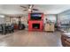 Living room with red brick fireplace, dining area and hardwood floors at 1920 Wendell Ave, Las Vegas, NV 89101