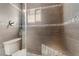 Large shower with gray tile, built-in seat, and a window at 1920 Wendell Ave, Las Vegas, NV 89101