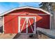 Large red storage shed with double doors in backyard at 1920 Wendell Ave, Las Vegas, NV 89101