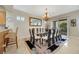 Elegant dining room with glass table, chandelier, and seating for twelve at 2080 Twin Falls Dr, Henderson, NV 89044