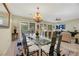 Spacious dining room with large glass table and chandelier, seating for 12 at 2080 Twin Falls Dr, Henderson, NV 89044