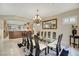 Formal dining room with glass-top table, chandelier, and seating for twelve at 2080 Twin Falls Dr, Henderson, NV 89044