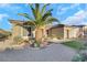 House exterior featuring a three-car garage and desert landscaping at 2080 Twin Falls Dr, Henderson, NV 89044