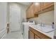 Laundry room with washer, dryer, and cabinets at 2080 Twin Falls Dr, Henderson, NV 89044