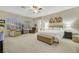 Main bedroom with seating area and large windows, plus a ceiling fan at 2080 Twin Falls Dr, Henderson, NV 89044