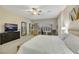 Main bedroom with seating area and large windows, plus a ceiling fan at 2080 Twin Falls Dr, Henderson, NV 89044