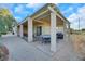 Covered patio with seating and dining areas, adjacent to a grilling station at 2080 Twin Falls Dr, Henderson, NV 89044