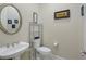 Powder room with pedestal sink, toilet, and decorative accents at 2080 Twin Falls Dr, Henderson, NV 89044