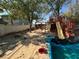 This backyard features a playhouse with slide and unfinished pool at 2127 Crawford St, North Las Vegas, NV 89030