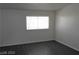 Simple bedroom with large window and dark grey flooring at 2139 Crawford St, North Las Vegas, NV 89030