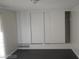 Bedroom with large mirrored closet and dark grey flooring at 2139 Crawford St, North Las Vegas, NV 89030