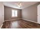 Bedroom with wood-look flooring, a ceiling fan, and a window with shutters at 2200 S Fort Apache Rd # 2050, Las Vegas, NV 89117