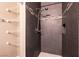 Walk-in shower with dark tile and built-in shelving at 2200 S Fort Apache Rd # 2050, Las Vegas, NV 89117