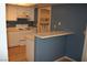 Kitchen with white cabinets, blue walls, and a breakfast bar at 2616 Aracatuba Ave, Las Vegas, NV 89121