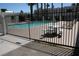 Sparkling community pool with lounge chairs and a gated entrance at 2616 Aracatuba Ave, Las Vegas, NV 89121