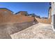 Landscaped backyard with block wall and dirt at 2642 Snapdragon Falls Ave # 93, North Las Vegas, NV 89081