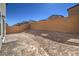 Landscaped backyard with block wall and dirt at 2642 Snapdragon Falls Ave # 93, North Las Vegas, NV 89081