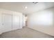 Spacious bedroom with double-door closet and hallway access at 2642 Snapdragon Falls Ave # 93, North Las Vegas, NV 89081